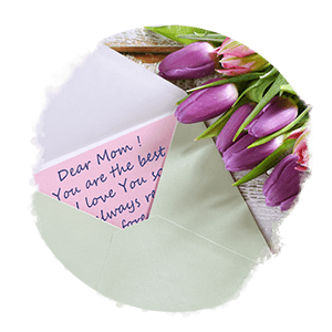 Mother's Day Letter in an open envelope with a bouquet of purple tulips next to it