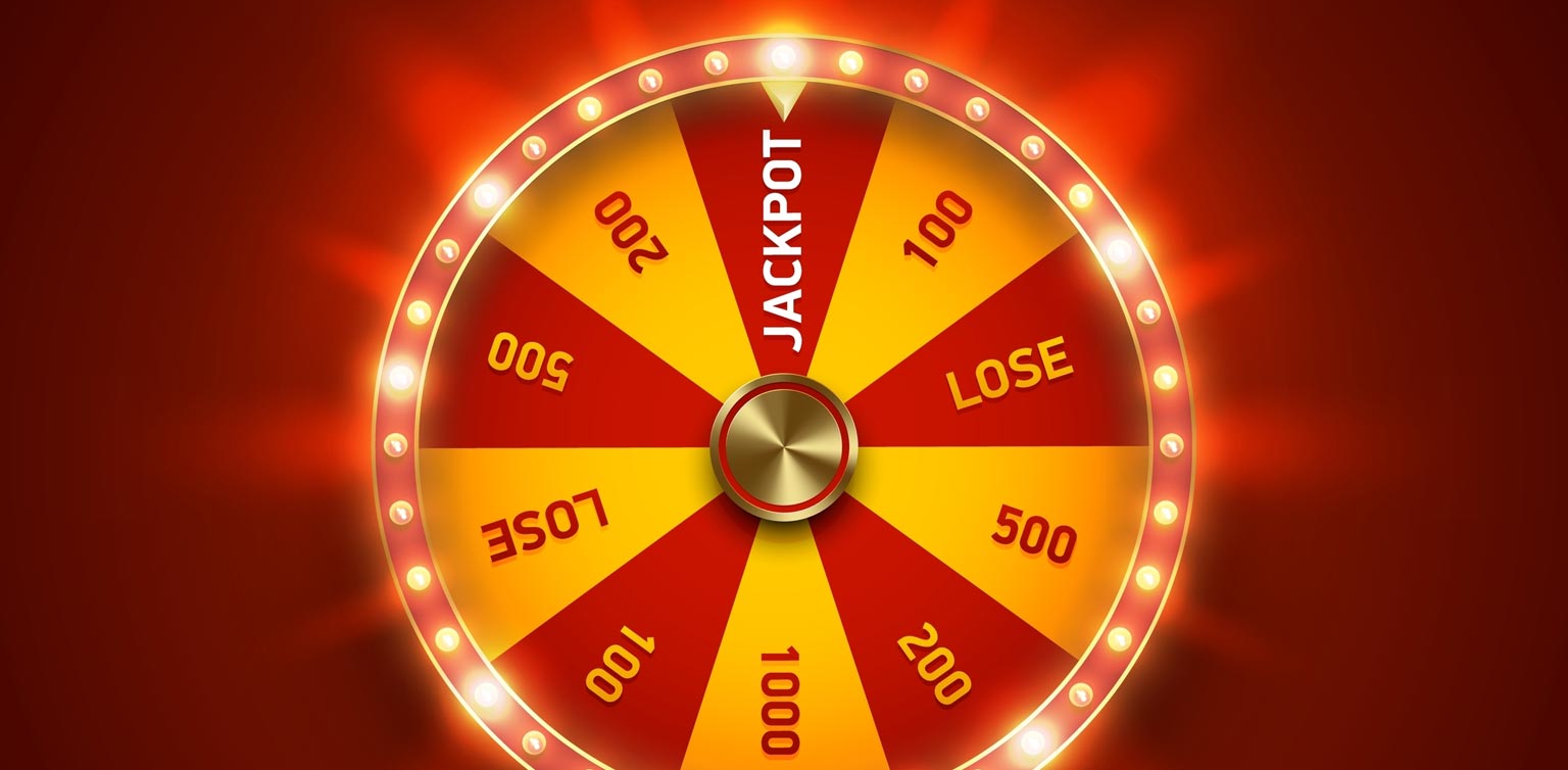 A retro style red and orange wheel of fortune encircled by lights with one pointed at the ‘jackpot’ segment on a red background
